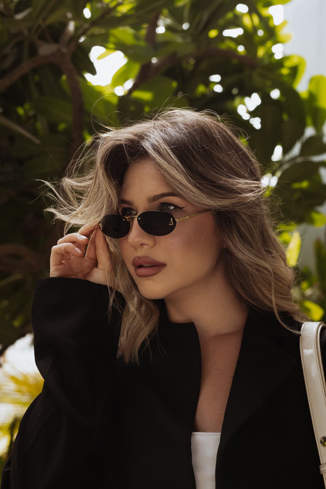 A TRIÉ founder in sunglasses amid the greenery