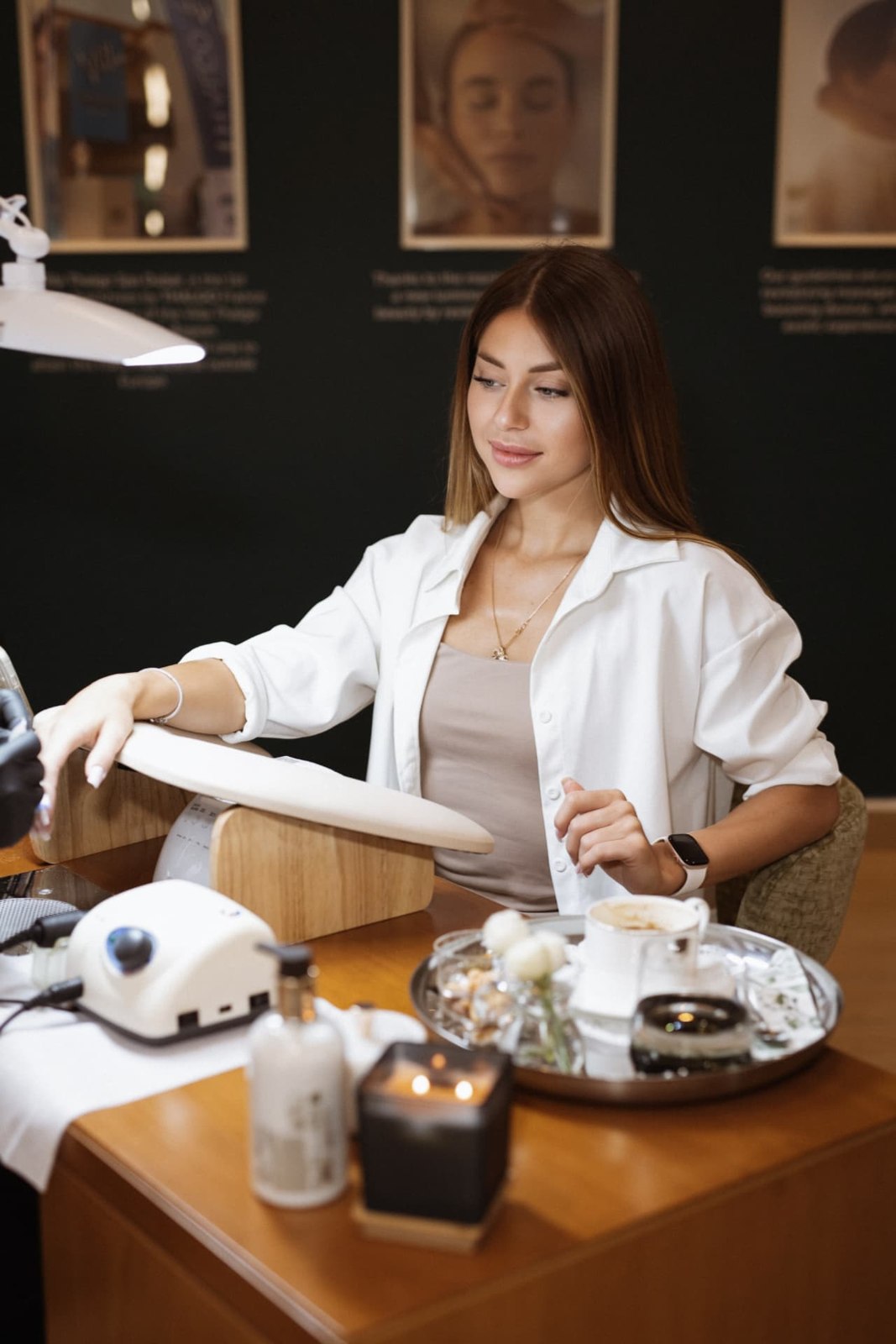 A client enjoying a quiet moment at the manicure table