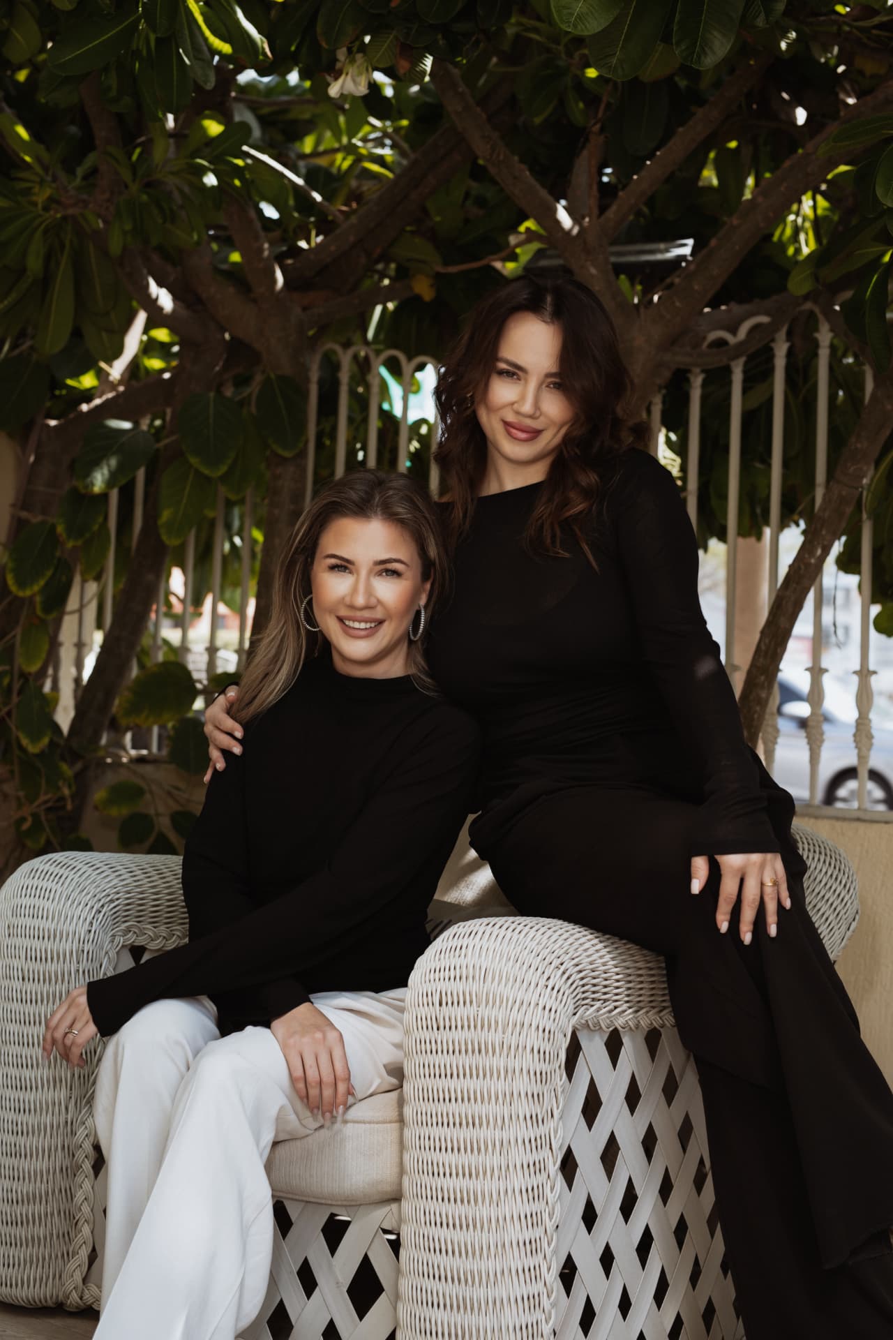 The two TRIÉ founders sharing a warm moment in the salon