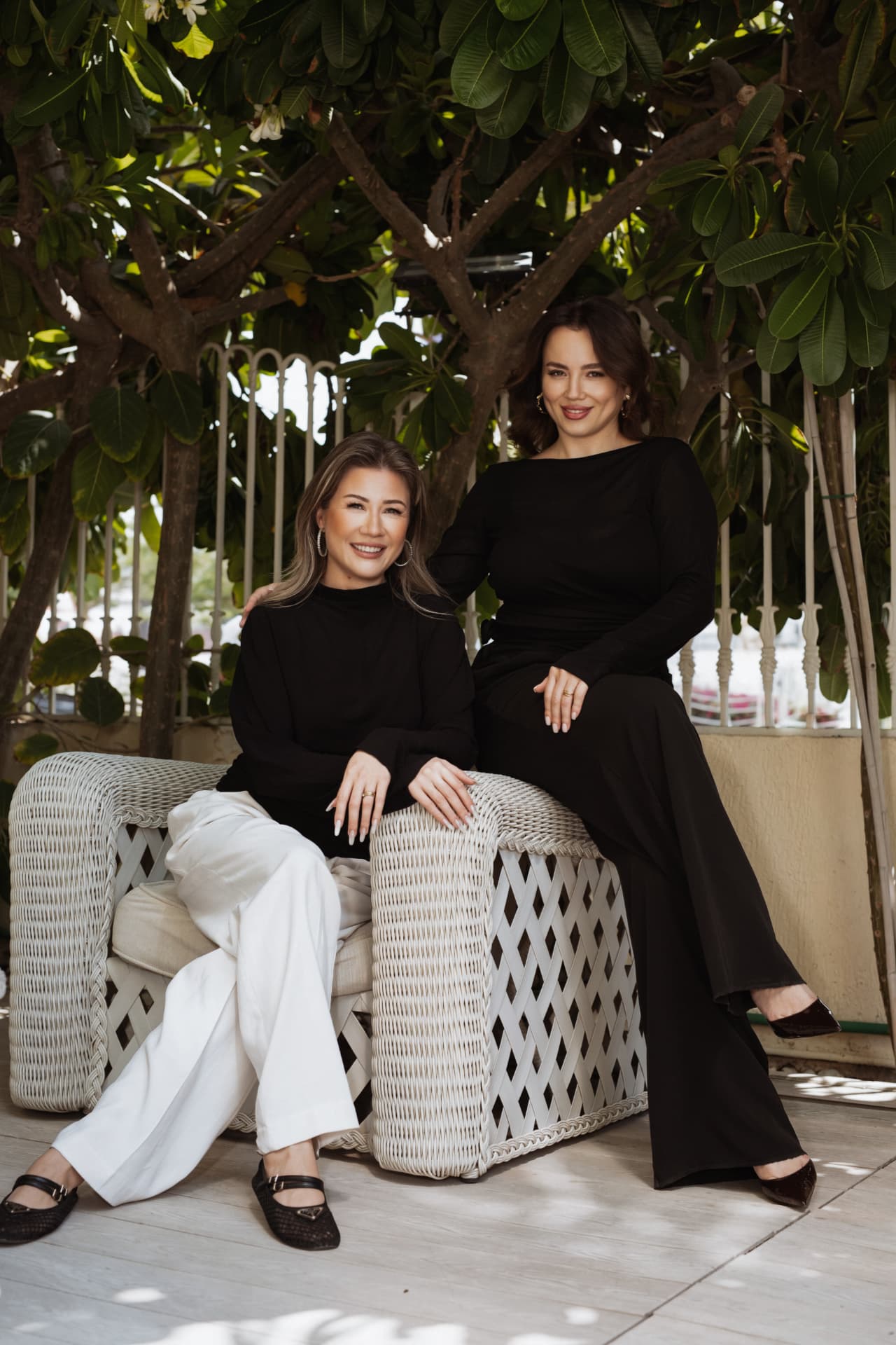 The two TRIÉ founders seated together on the salon terrace