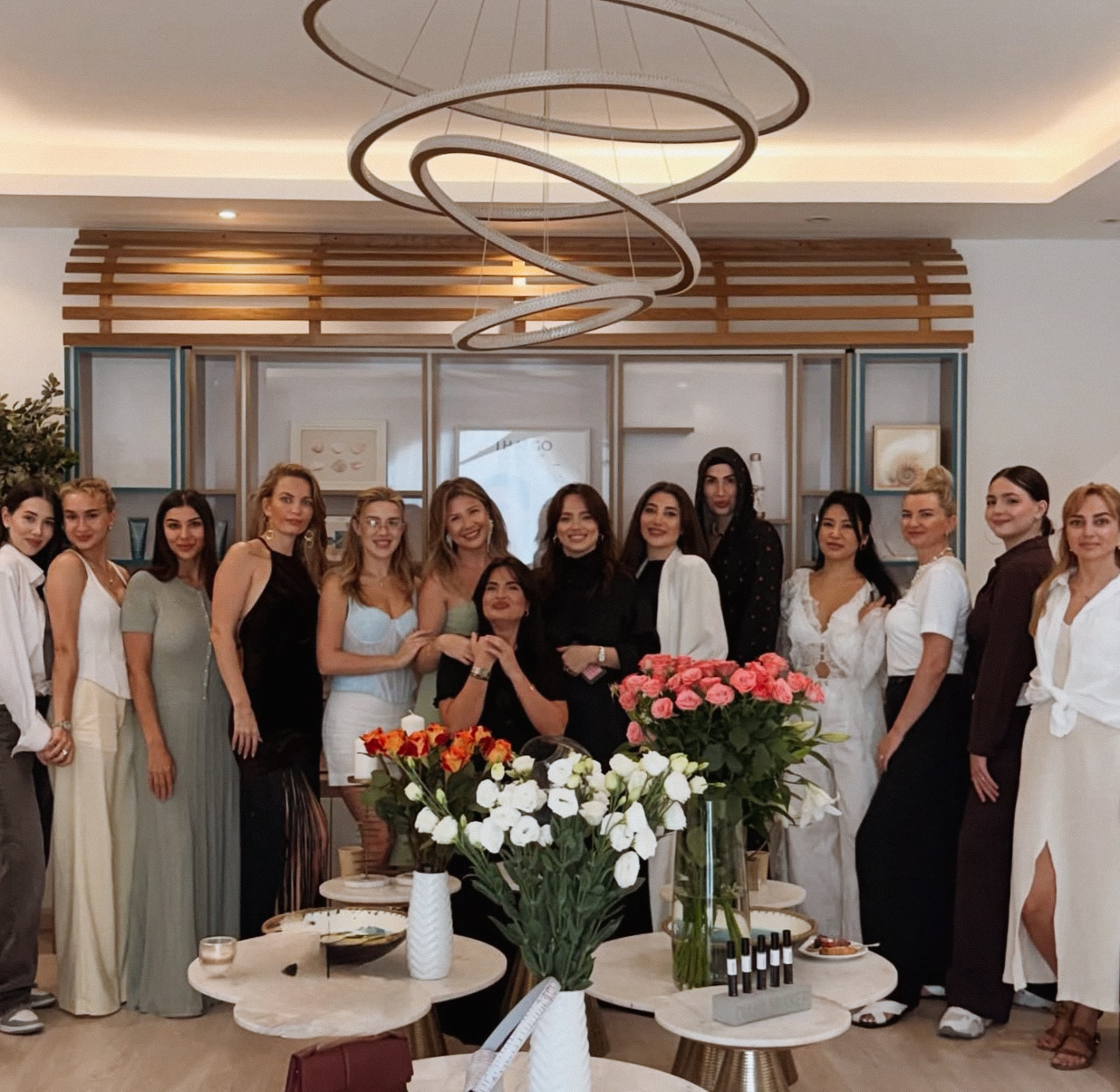 Guests gathered together at TRIÉ with flowers in the salon