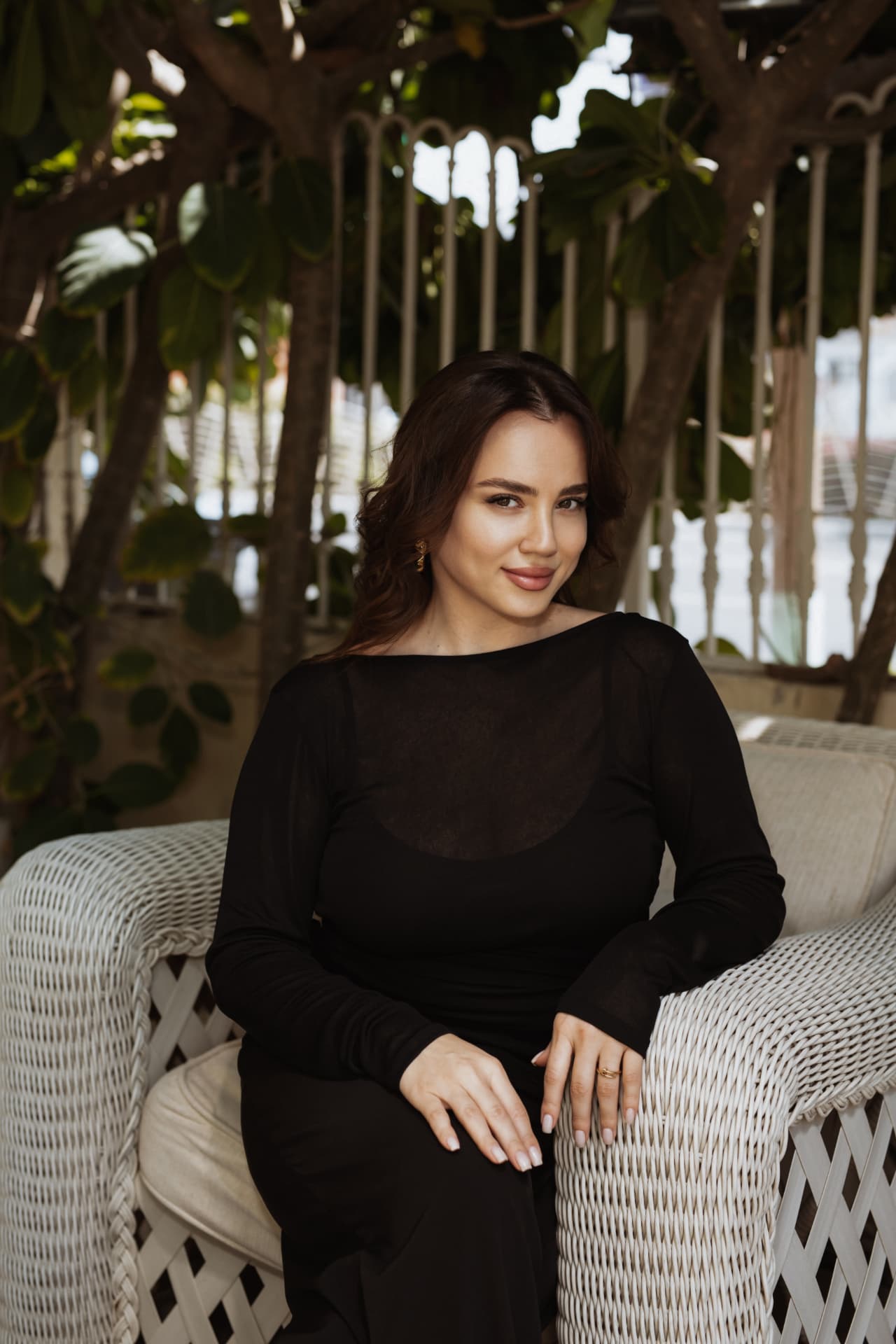 A TRIÉ founder seated in a wicker salon armchair